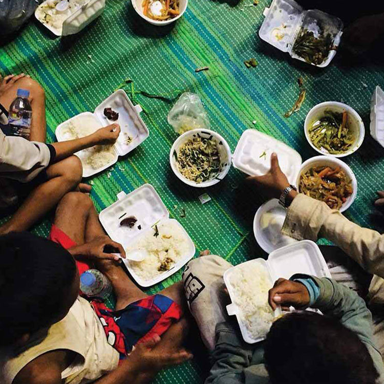 A group of children eating food. 